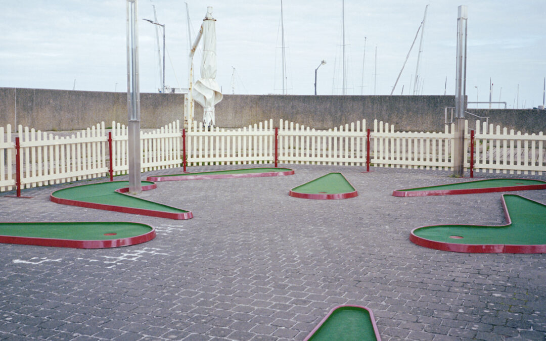 A landscape image of an empty pitch and putt arena