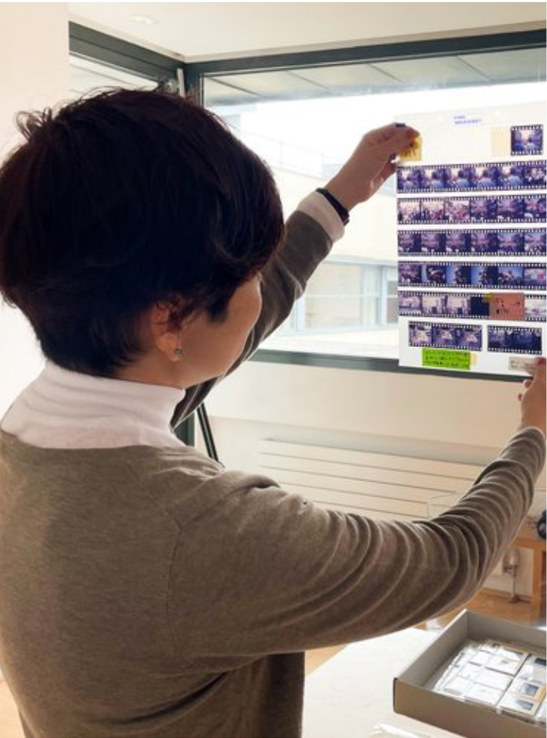 woman looking at negatives