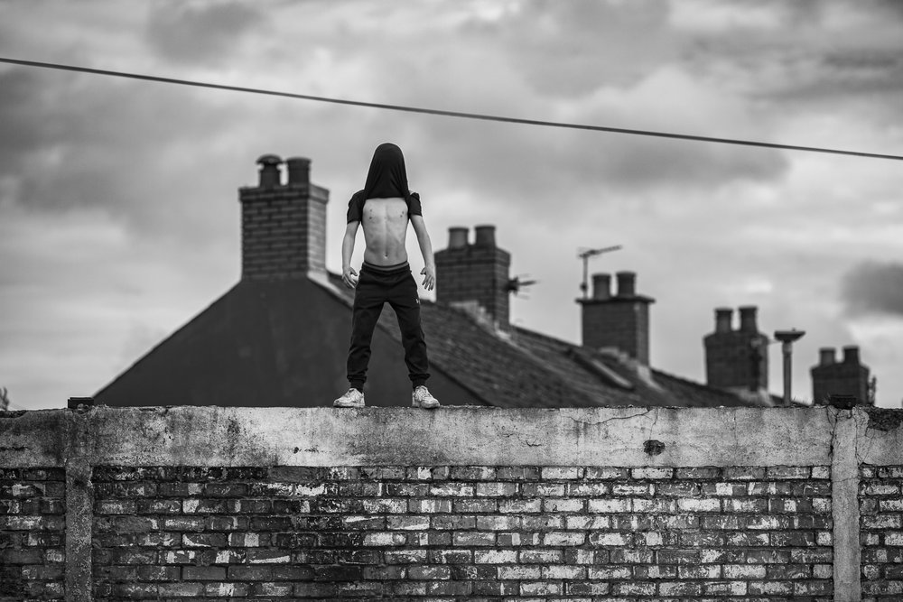 man standing on top of a wall