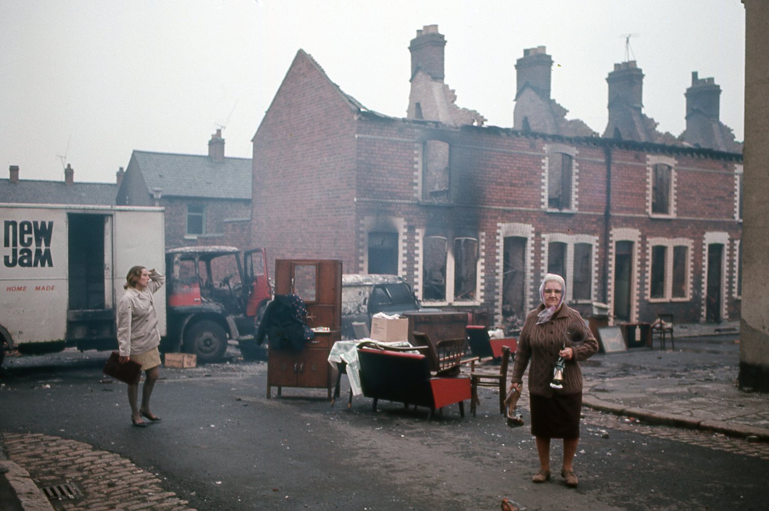 woman in a street with pieces of furniture