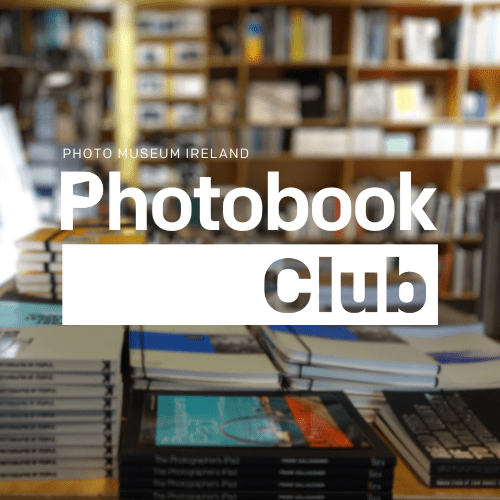 The words Photobook Club overlaid on an image of books on display at the Photo Museum Ireland bookshop.