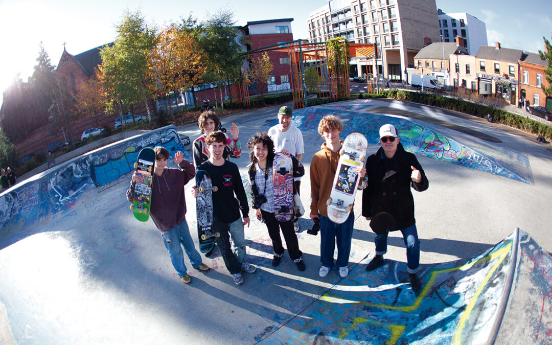 Group photograph of skateboarders in a skate park.