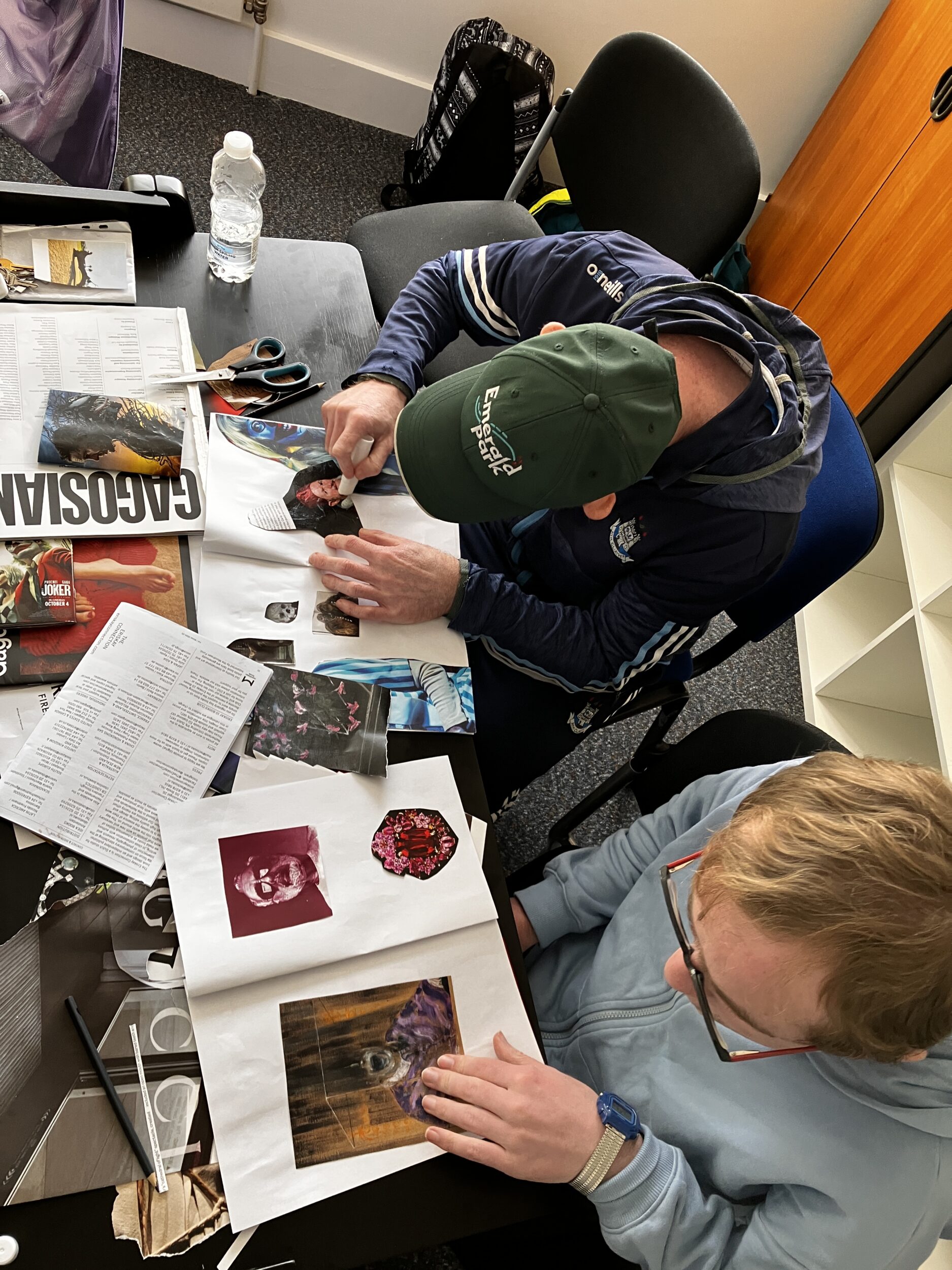 Image of two people working with photography and creating zines.